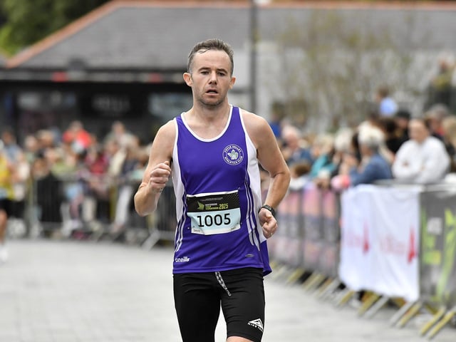 David Laird, Foyle Valley AC, finishes the 2025 Waterside Half Marathon. Photo: George Sweeney