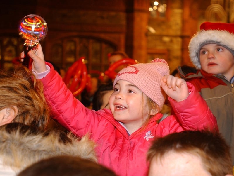 IT'S SANTA - Five years-old Rebecca Lamberton cheers as she sees Santa arrive in Derry on Wednesday night to smitch on the Christmas Lights. (1911C43) : Christmas Lights Switch on, from November 2004 in the Guildhall Square.
