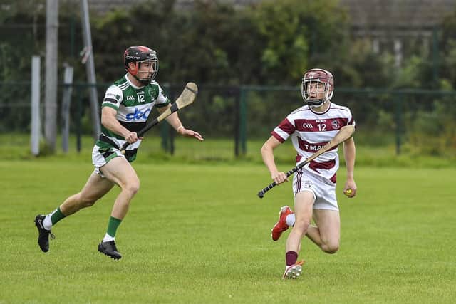 Mark McCloskey of Na Magha closes in on Slaughtneil’s Eunan Boylan. Photo: George Sweeney