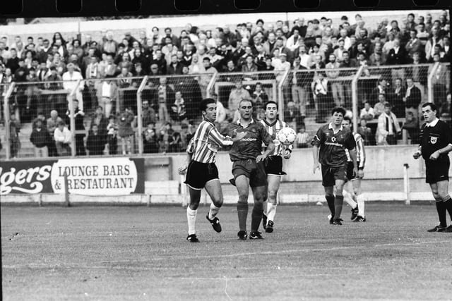 Vinnie Jones and Gary Heaney contest the ball at the Brandywell