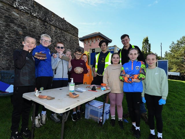 Gaelscoil Eadain Mhoir pupils pictured with Queen’s University archaeologists Ethan and Oliver at the archaeology dig in an area beneath the City Walls. Photo: George Sweeney