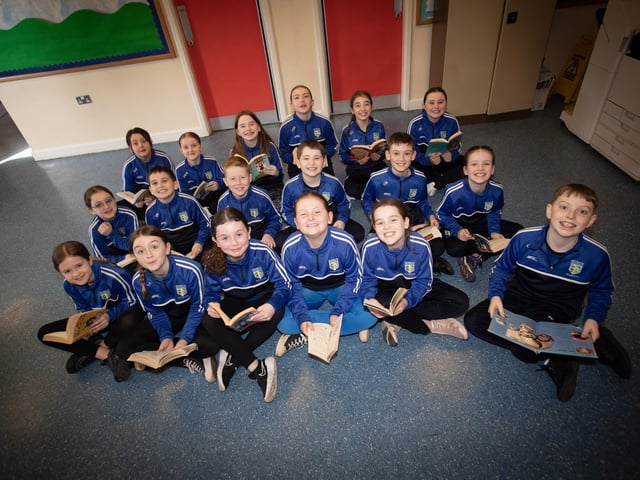 Hollybush PS swimming team get in some reading practice before swimming on Thursday last.