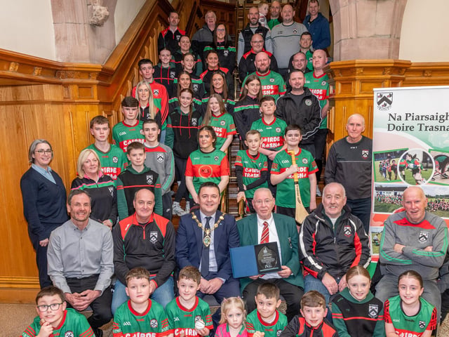 Doire Trasna GAC who are celebrating their 25th Anniversary received a commemorative crystal gift from the Mayor Councillor Ruairi McHugh in the Guildhall to mark their outstanding contribution to sport, community life and promotion of Gaelic games. During the evening the club’s traditional band and Irish dancers entertained guest with performances. The award was received by club President, Eddie Nash, pictured with seated from left, Mark O’Doherty, Chairperson, Paul Simpson, Brian McKenna and Paddy McNaught who are founding members of the Club. Picture Martin McKeown. 22.01.26