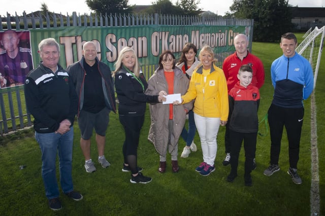 CHEQUE HANDOVER. . . . . .Mrs. Ciara Deane, Principal, St. Joseph’s Boys School and Mrs. Breige O’Kane pictured handing over a cheque from the Sean O’Kane Memorial Cup to Linda Sturgeon, Marie Curie, proceeds from the weekend’s tournament at the school. Sean, who passed away last year, was a teacher at the school. Included from left are Paul Kealey, Vice Principal, Paul Gibbons, teacher/organiser, Colleen O’Kane, Christy McGeehan, organiser, Benjamin McGeehan and Emmett McGinty, teacher/organiser. (Photos: Jim McCafferty Photography)
