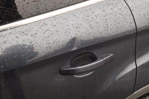 A dent caused by a brick thrown by youths towards a PSNI Land Rover parked at the Iniscarn Crescent entrance to the City Cemetery.