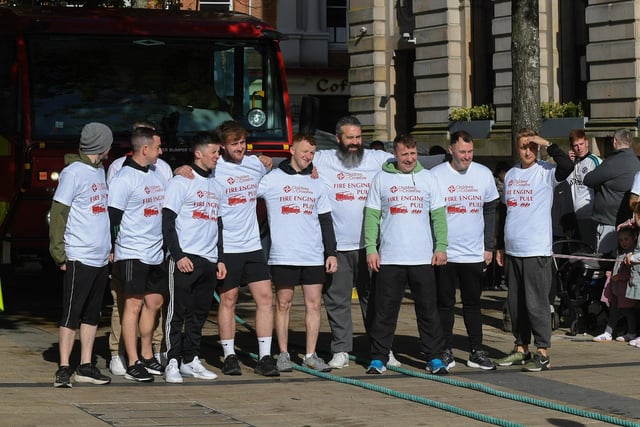 One of the fundraising teams who pulled a 32-tonne City of Derry Airport Fire and Rescue Engine, in Guildhall Square, in aid of Children In Crossfire.  Photo: George Sweeney