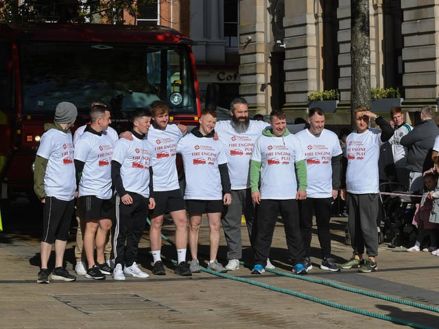 One of the fundraising teams who pulled a 32-tonne City of Derry Airport Fire and Rescue Engine, in Guildhall Square, in aid of Children In Crossfire. Photo: George Sweeney