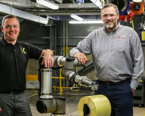Keith Stott, Project Team Leader at DuPont Maydown and Colin Spence, Director, FAST Technologies are pictured beside the new autonomous mobile robot which has advanced vision and software technology that will allow DuPont to work safer and faster in the production of Kevlar®.