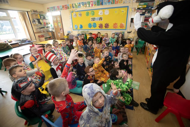 The Masked Reader surprises Primary 2 pupils at St. Brigid's PS during World Book Day on Thursday last. (Photos: Jim McCafferty Photography)