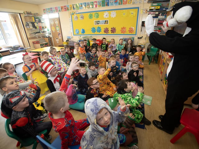The Masked Reader surprises Primary 2 pupils at St. Brigid's PS during World Book Day on Thursday last. (Photos: Jim McCafferty Photography)