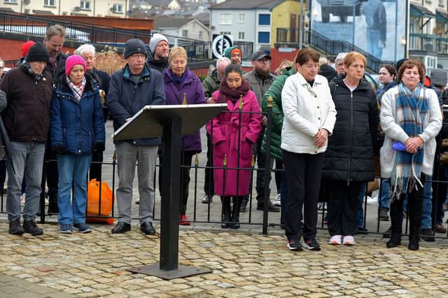 Relatives are joined by people at the Bloody Sunday monument at Joseph's Place on Monday afternoon for a one minute silence on the 51st anniversary of the Bloody Sunday massacre. Photo: George Sweeney. DER2306GS 39