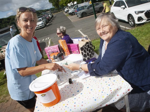 REGISTRATION. . . . Registrat for Saturday’s ‘Paws for Thought’ dog walk Irene Hewitt signing in Pauline McCloskey.