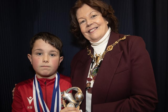 Newell Academy's Harry Morrow receives the U11 Player of the Year award from the Mayor, Patricia Logue.