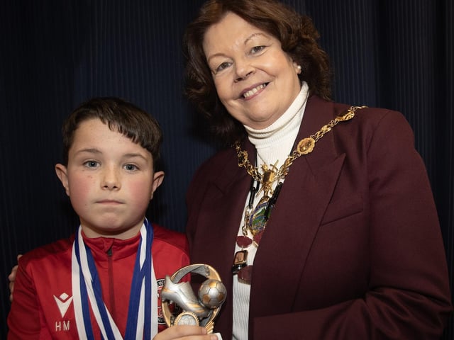 Newell Academy's Harry Morrow receives the U11 Player of the Year award from the Mayor, Patricia Logue.