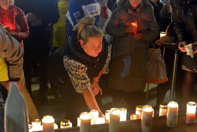 People place candles on the steps of the Guildhall at a vigil held on Monday evening to remember those who died in the Creeslough tragedy on Friday afternoon last.  Photo: George Sweeney.  DER2241GS – 58