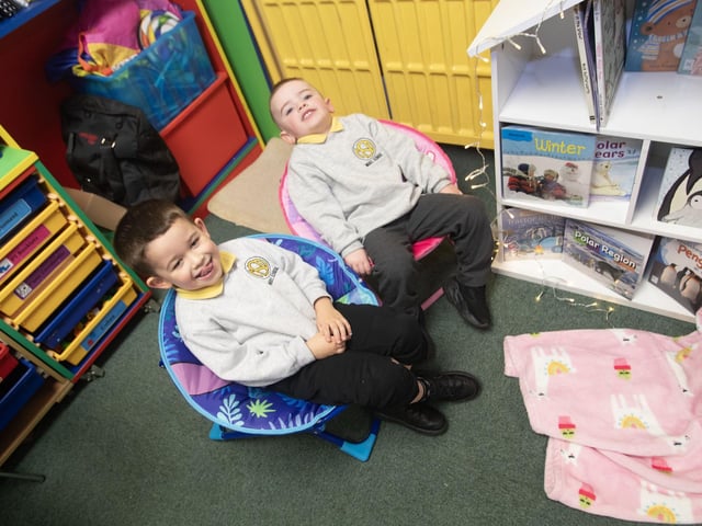 Testing out the quality of the chairs in the P1 classroom during Open Day at the Model PS. : .