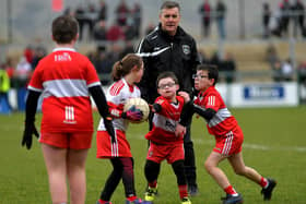 ARE YOU WATCHING, RORY? Some of the children who took part in a football game during half-time at Owenbeg on Sunday.  Photo: George Sweeney. DER2312GS – 32