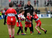 ARE YOU WATCHING, RORY? Some of the children who took part in a football game during half-time at Owenbeg on Sunday.  Photo: George Sweeney. DER2312GS – 32