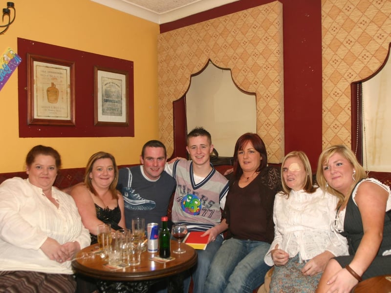 Birthday Boy Thomas seated centre with a group of friends having a good time . 692 /dd : .