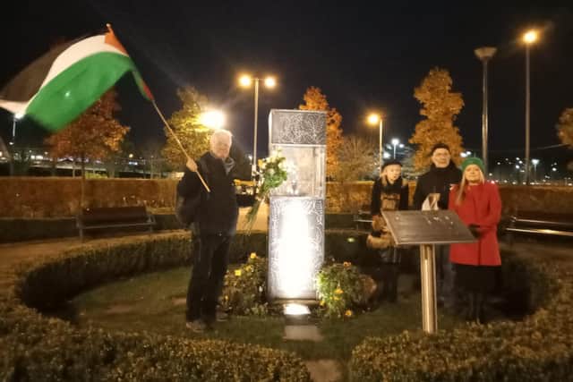 White roses are laid at the Peace Flame in Derry city centre.