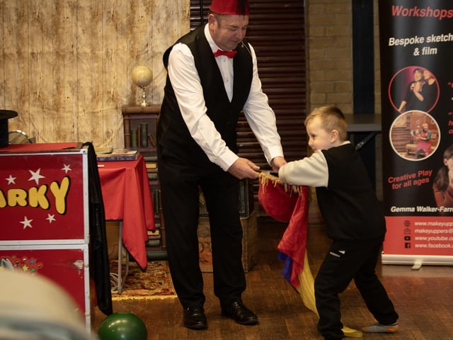 Five year old Theo helping Parky The Migician at Saturday's Feile Springtime Shenanigans at Pilot's Row Centre. (Photos: Jim McCafferty Photography) : .