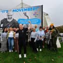 Group pictured at the launch of Hive's 'Movember' campaign billboard at Free Derry Wall. The board features a picture of Hives Male Support Worker Martin Mullan. Movember is an annual event involving the growing of moustaches during the month of November to raise awareness of awareness of mens mental health & prostate and testicular cancer. Included in the group photograph is Martin Mullan. Photo: George Sweeney