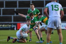 Ballymaguigan players surround James McLaughlin of Craigbane. Photo: George Sweeney