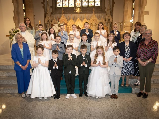 MODEL FIRST COMMUNION . . . . .Pupils from Model Primary School who received the Sacrament of First Holy Communion from Fr. Colum Clerkin at St. Eugene's Cathedral on Friday afternoon last. Included in photo are Ms. Julie O'Loughlin, Principal, Mrs. Joanne O'Connor, and on right, Mrs. McCool,Mrs Penny Cromie, Mrs Ruth Johnston and Mrs Susan Devenny. (Photos: Jim McCafferty Photography)