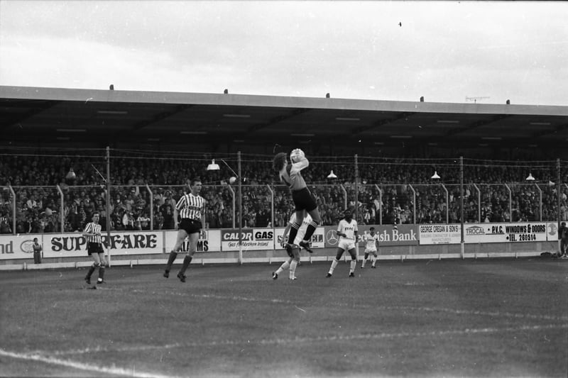 Tim Dalton gathers the ball to the relief of Paul Curran and Kevin Brady.