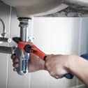 plumber fixing a sink.