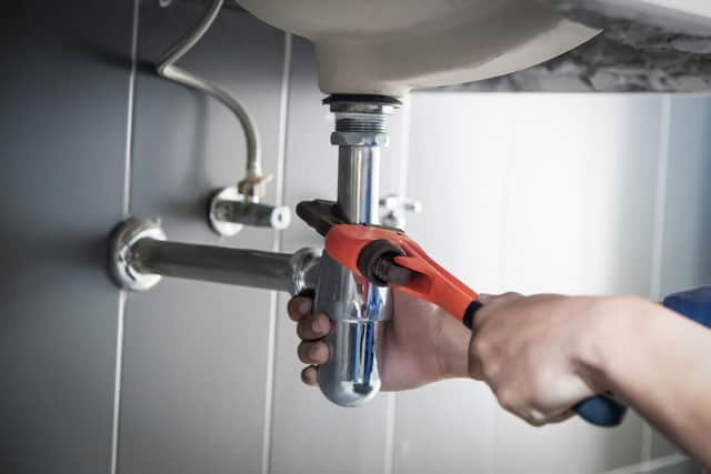 plumber fixing a sink.