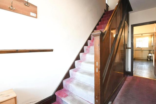 The hallway includes the stairs, which take you to the first floor and the three bedrooms.