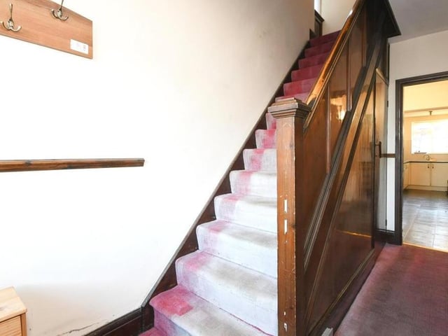 The hallway includes the stairs, which take you to the first floor and the three bedrooms.