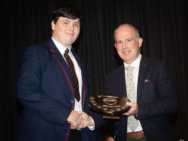 Jakob Healy collecting the Crawford Award for Commitment to work at last week's Oakgrove College Senior Prizegiving from Mr. David Middleton, Head of Year.