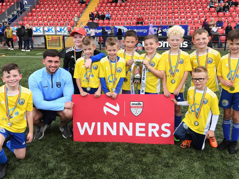 O'Neills staff member Charlie White pictured with the Moyola Park team which lifted the O'Neills Foyle Cup Under-8's title at The Brandywell on Friday.