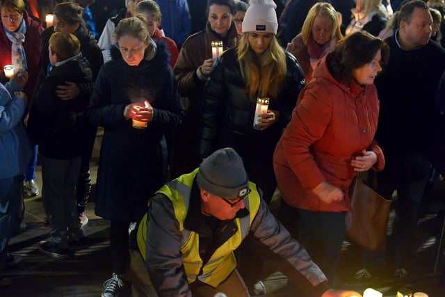 People place candles on the steps of the Guildhall during a vigil held on Monday evening to remember those who died in the Creeslough tragedy on Friday afternoon last.  Photo: George Sweeney.  DER2241GS – 57
