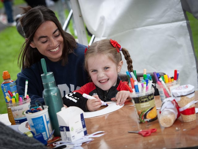Four years-old Evie Lamberton shows her mum how to plate paint during Monday's Féile 23 event in Creggan.