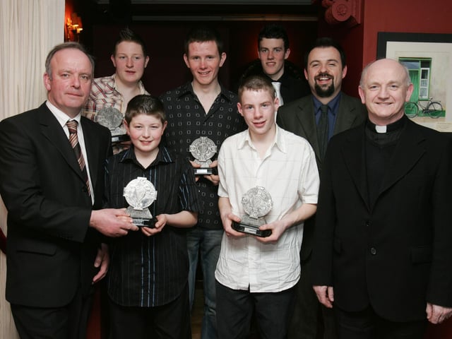 Mick Murphy, County Games Coaching manager, left, presenting the Underage Player of the Year Awards. Included, from left, are Gary Monagle (U-14), Seamus Houton (U-12), Michael Doherty (Minor) Cathal Kelly (U-13), Conor Farren (U-16), Rev. David Hagan, Rector, and Rev. Brian Brady, PP, Malin. (2102C44) : Malin GAA Dinner