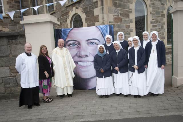 Bishop Dónal McKeown, Shauna Crockett and Fr. Gerard Mongan pictured with some of the Carmelite nuns who attended Sunday’s Mass at the Long Tower Church.