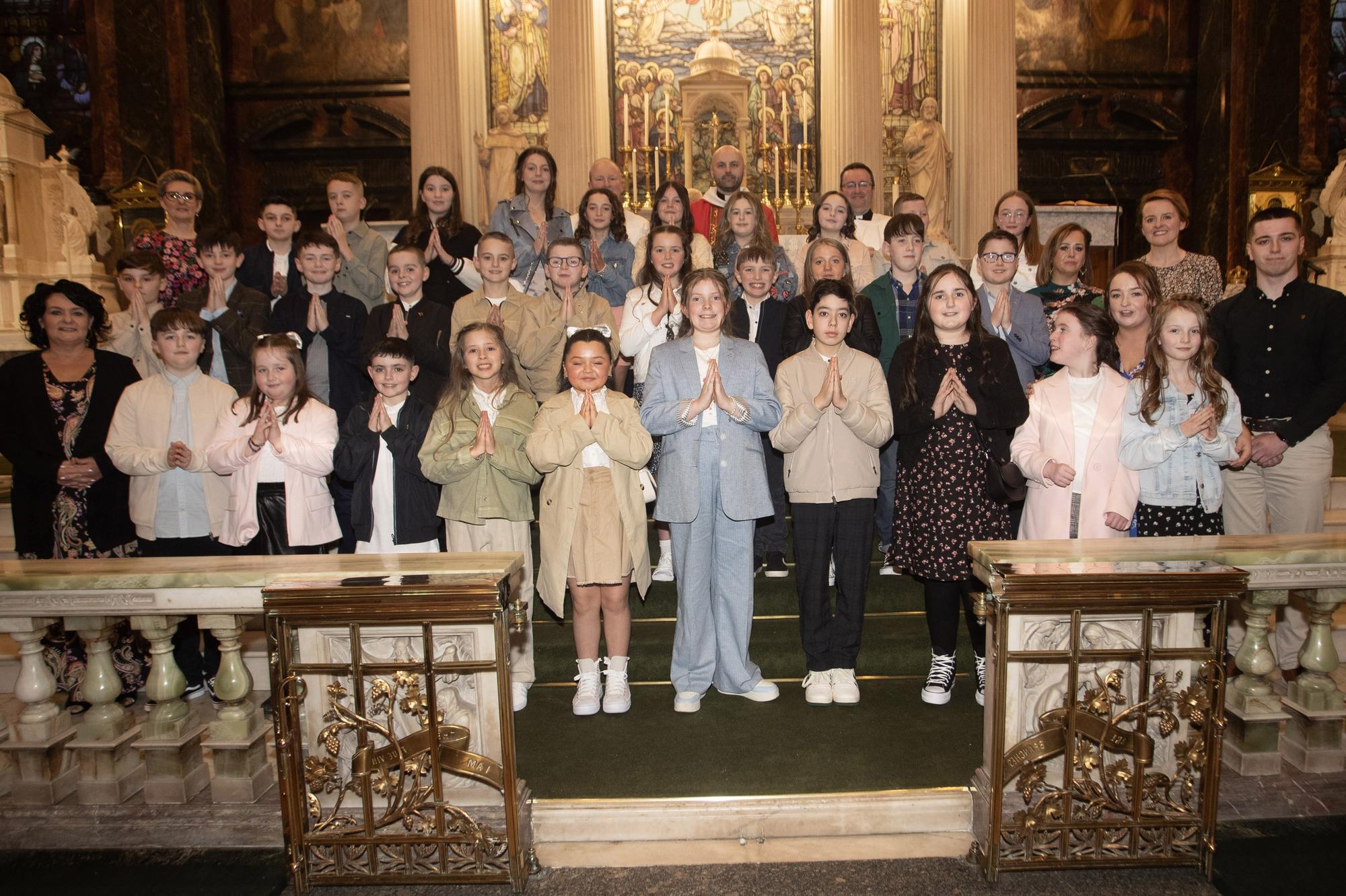 Pupils from Nazareth House Primary School who received the Sacrament of Confirmation from Fr. Chris McDermott at Long Tower Church on Thursday evening last. Included are Fr. Gerard Mongan and Fr. Stephen Ward. On left, Mrs Julia Cooke and Ms Joanne Dixon. On right Mr Adam Doherty (student teacher), Mrs Emma Courtney and Ms Maureen Clark and Mrs. Roisin Blackery, Principal.  (Photos: Jim McCafferty Photography)