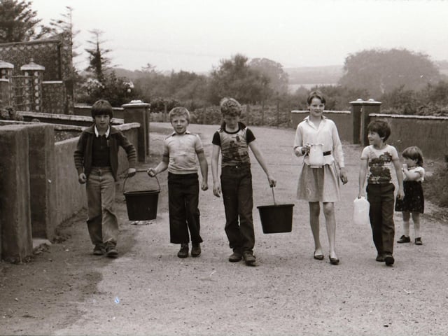 Children carrying pails of water back in 1984.