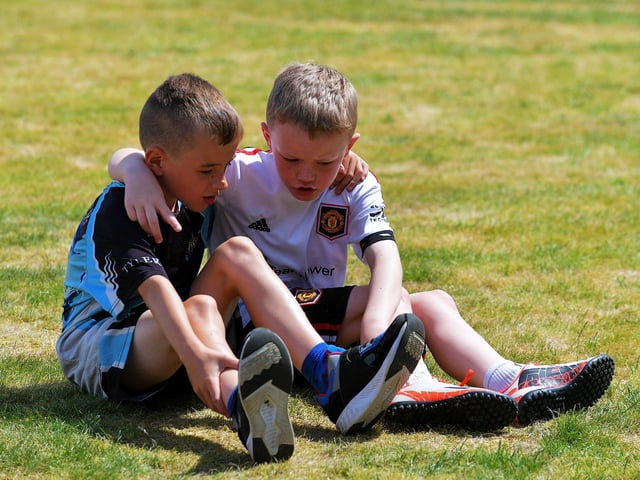 Friends discuss tactics at the Holy Child Primary School sports day held on Monday last. Photo: George Sweeney. DER2325GS – 015