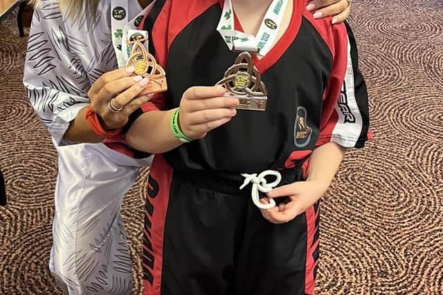 Team NI President, Fineen Bradley, celebrates with Mikey Bradley, who picked up a silver medal at last week's WKC World Championships in Killarney.