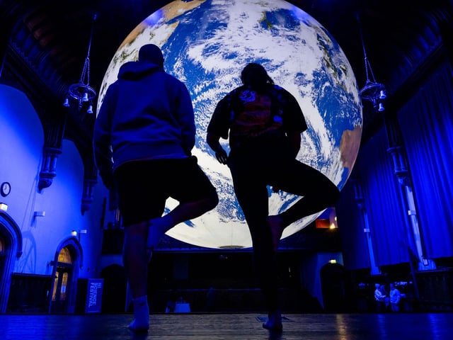 One of the morning wellbeing sessions take place beneath Luke Jerram’s giant floating Earth sculpture Gaia inside the Guildhall as part of Derry Halloween. The sessions lasting around 45 minutes include morning Pilates, meditation, breath awareness, gentle movement, Famo Fascia Movement, and sensory sessions. Picture Martin McKeown. 28.10.26