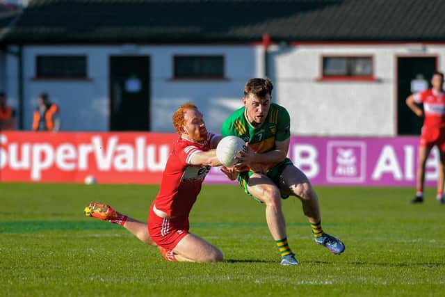 Derry’s Conor Glass grapples with Shane O’Donnell of Donegal. Photo: George Sweeney