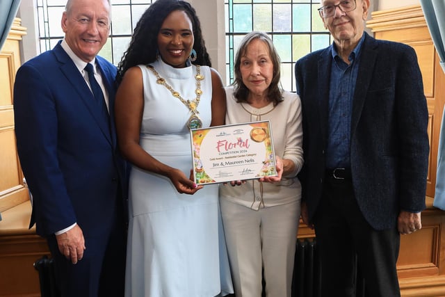 Mayor Lilian Seenoi Barr presents the City Centre Initiative Floral Competition 2024 Gold Award (Residential Garden Category) to Maureen and Jim Nelis. Included on the left is Jim Roddy, CEO of City Centre Initiative. (Photo - Tom Heaney, nwpresspics)