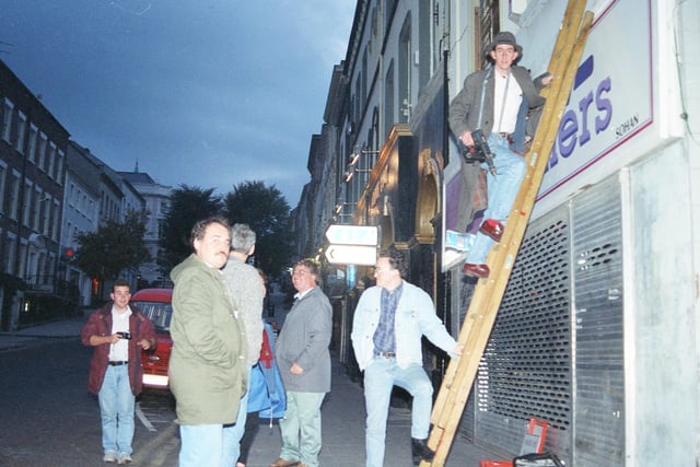 RUC officers arrive on the scene as the first city centre street signs in Irish are erected at Shipquay Street in 1992.