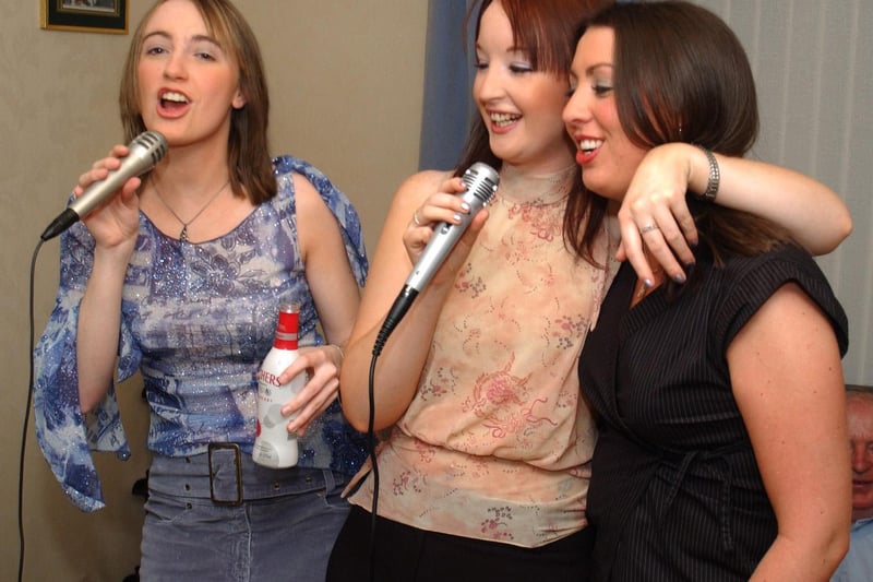 Margaret McPhilips, Louise McLaughlin and Caireen McPhilips get into the party spirit on the Kareoke machine at Caireen's 21st birthday. 