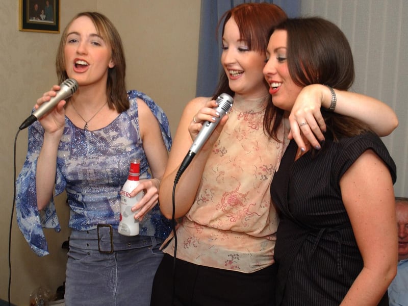 Margaret McPhilips, Louise McLaughlin and Caireen McPhilips get into the party spirit on the Kareoke machine at Caireen's 21st birthday. 