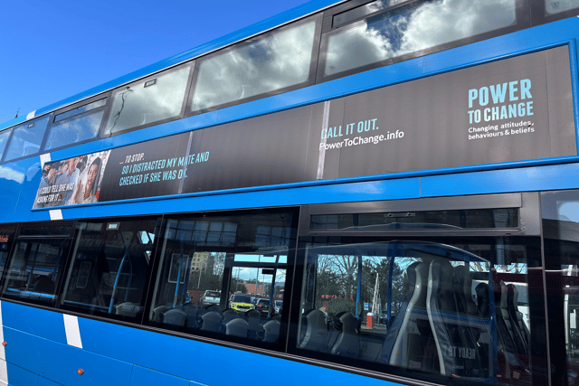 One of the buses leaves Foyle Street depot with Power To Change messaging on the side.